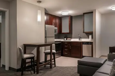a kitchen with a table and chairs and a refrigerator at Residence Inn by Marriott Akron Fairlawn in Fairlawn