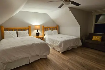 a bedroom with two beds and a couch at GameRoom, HotTub, Piano, 5mi to OldManCave - Hocking Hills Copper House in Laurelville