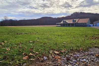 a house in the middle of a grass field at GameRoom, HotTub, Piano, 5mi to OldManCave - Hocking Hills Copper House in Laurelville