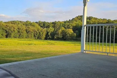 an open gate with a field and trees in the background at GameRoom, HotTub, Piano, 5mi to OldManCave - Hocking Hills Copper House in Laurelville