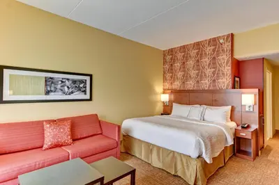 a hotel room with a bed and a couch at Courtyard by Marriott Bridgeport Clarksburg in Bridgeport