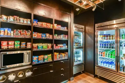a kitchen with a refrigerator and a microwave at Courtyard by Marriott Bridgeport Clarksburg in Bridgeport