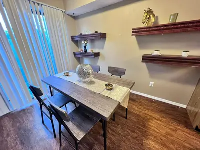 a dining room with a wooden table and chairs at The Cozy Townhouse WPAFB & WSU in Fairborn