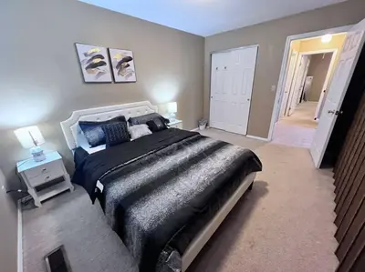 a large bedroom with a large bed and a hallway at The Cozy Townhouse WPAFB & WSU in Fairborn