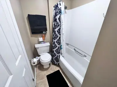 a small bathroom with a toilet and a shower at The Cozy Townhouse WPAFB & WSU in Fairborn