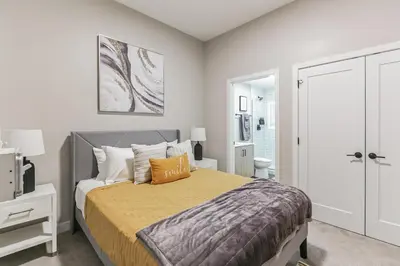 a bedroom with a large bed and a bathroom at Downtown Stroll to the Bengals in Cincinnati