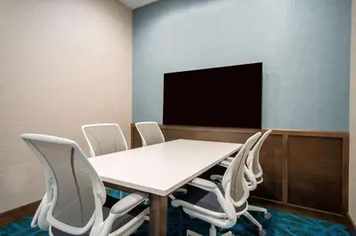 a conference room with a table and chairs and a tv at Home2 Suites By Hilton West Chester Cincinnati in West Chester