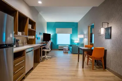 a kitchen with a table and a dining room at Home2 Suites By Hilton West Chester Cincinnati in West Chester