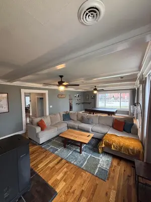 a living room with a couch and a table at Birchill Manor in Brookville