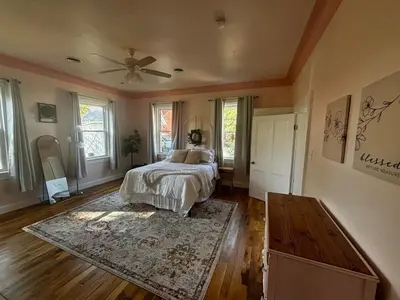 a bedroom with a bed and a ceiling fan at Birchill Manor in Brookville