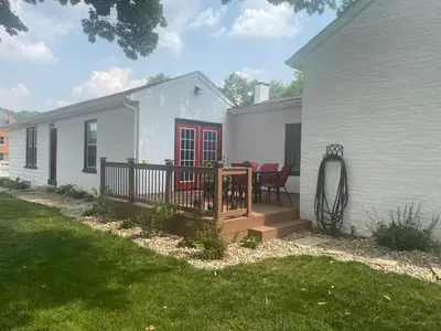 a backyard with a deck and a house at Birchill Manor in Brookville