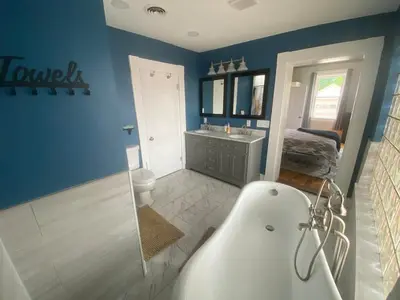 a bathroom with a tub and a toilet and a sink at Birchill Manor in Brookville