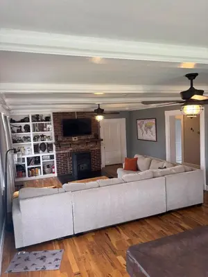 a living room with a couch and a fireplace at Birchill Manor in Brookville