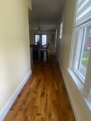 an empty living room with a hard wood floor at Birchill Manor in Brookville