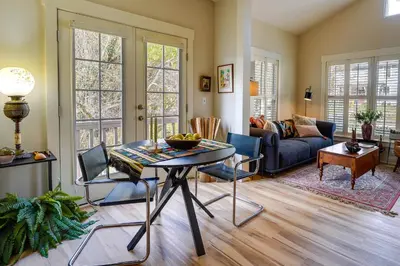 a living room with a table and a couch at Charming Granville Home with Porch - Walk Downtown! in Granville