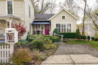 a white house with a red door at Charming Granville Home with Porch - Walk Downtown! in Granville