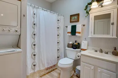a white bathroom with a toilet and a sink at Charming Granville Home with Porch - Walk Downtown! in Granville
