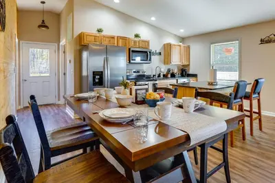 a kitchen and dining room with a table and chairs at Serene Logan Retreat with Hot Tub and Stargazing Dome in Logan