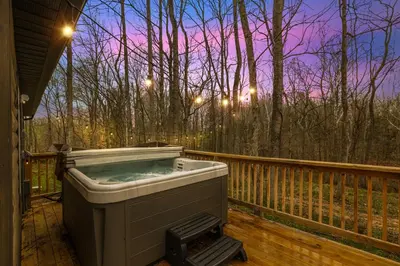 a hot tub on the deck of a house at Serene Logan Retreat with Hot Tub and Stargazing Dome in Logan