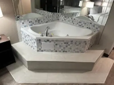 a bath tub in a bathroom with a mirror at Red Roof Inn Charleston - Dunbar in Dunbar