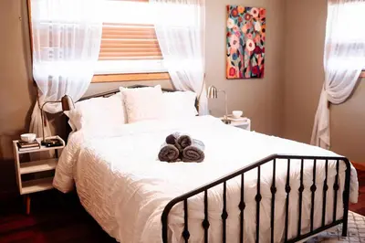 a bedroom with a bed with a teddy bear on it at Spacious Five-Bedroom Bliss in Fairlawn