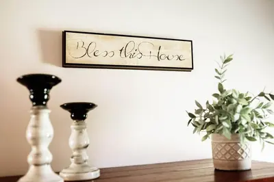a shelf with two vases and a sign that reads see this here at Spacious Five-Bedroom Bliss in Fairlawn