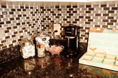 a counter with a coffee maker on a counter top at Spacious Five-Bedroom Bliss in Fairlawn