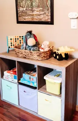 a shelf with toys and baskets on top of it at Spacious Five-Bedroom Bliss in Fairlawn