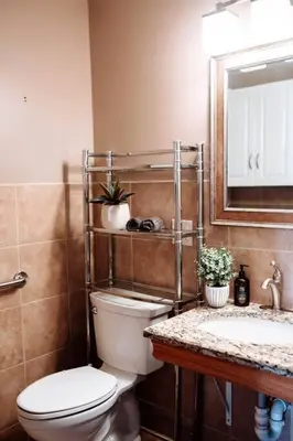 a bathroom with a toilet and a sink and a mirror at Spacious Five-Bedroom Bliss in Fairlawn