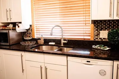 a kitchen with a sink and a microwave at Spacious Five-Bedroom Bliss in Fairlawn