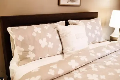 a bed with white flowers on it with pillows at Spacious Five-Bedroom Bliss in Fairlawn