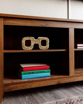 a book shelf with books and a pair of glasses at Maple Heights Oasis - Libby Unit 5 in Maple Heights