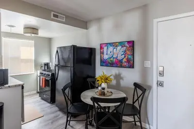 a kitchen with a table with chairs and a refrigerator at Maple Heights Oasis - Libby Unit 5 in Maple Heights