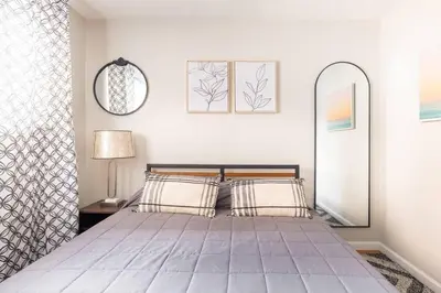 a bedroom with a large bed and a mirror at King & Queen First Floor Unit! 1-2c Georgetown Villas in Fairview Park