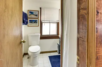 a bathroom with a toilet and a window at Chagrin Falls Home about 2 Mi to Town! in Chagrin Falls