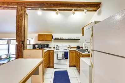 a kitchen with white appliances and wooden cabinets at Chagrin Falls Home about 2 Mi to Town! in Chagrin Falls