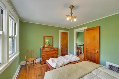 a bedroom with a bed and a dresser and a mirror at Near Downtown Cincinnati Peaceful Retreat! in Blue Ash
