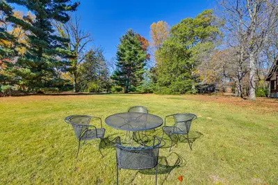 a glass table and chairs in a field at Near Downtown Cincinnati Peaceful Retreat! in Blue Ash
