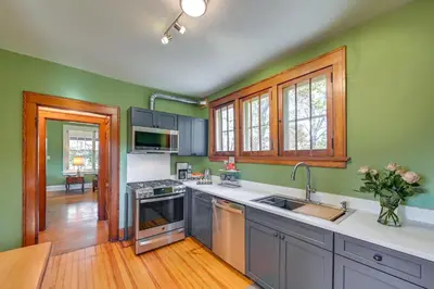 a kitchen with green walls and stainless steel appliances at Near Downtown Cincinnati Peaceful Retreat! in Blue Ash