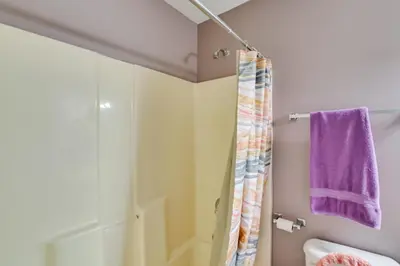 a bathroom with a shower and a purple towel at Georgetown Home about 6 Mi to Kentucky Horse Park! in Georgetown
