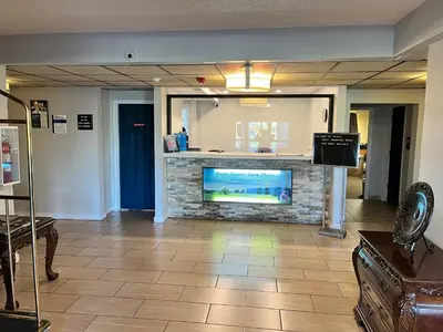 a living room with a fireplace with a tv at Studio 6 Suites Springfield, OH in Springfield