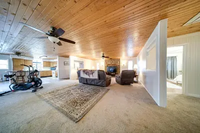 a living room with a ceiling fan and a couch at North Jackson Vacation Rental with Wraparound Deck! in North Jackson