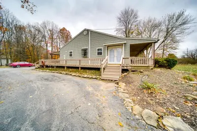 a house with a porch and a driveway at North Jackson Vacation Rental with Wraparound Deck! in North Jackson
