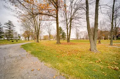 a road in a park with trees and grass at North Jackson Vacation Rental with Wraparound Deck! in North Jackson