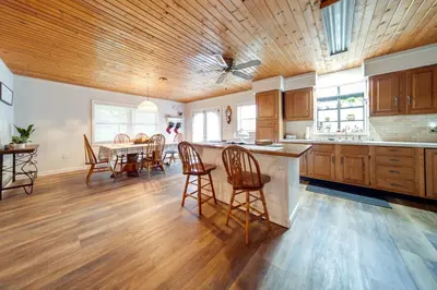 a kitchen with a table and chairs and a dining room at North Jackson Vacation Rental with Wraparound Deck! in North Jackson
