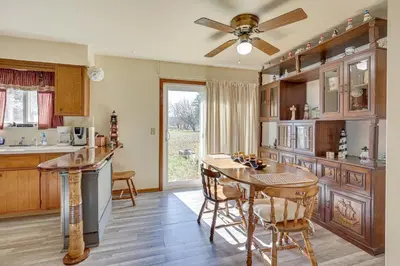a kitchen with a table and a ceiling fan at Family-Friendly Home with Fire Pit about 10 Mi to Akron! in Uniontown