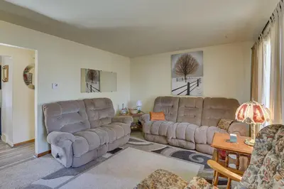 a living room with two couches and a table at Family-Friendly Home with Fire Pit about 10 Mi to Akron! in Uniontown