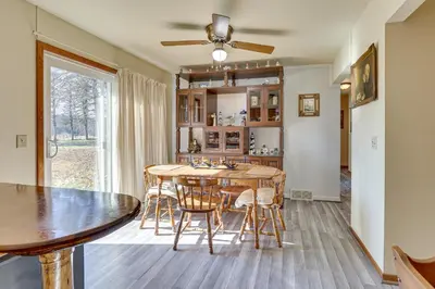 a kitchen and dining room with a table and chairs at Family-Friendly Home with Fire Pit about 10 Mi to Akron! in Uniontown
