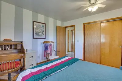 a bedroom with a bed with a dresser and a desk at Family-Friendly Home with Fire Pit about 10 Mi to Akron! in Uniontown