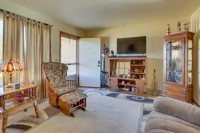 a living room with a couch and a chair at Family-Friendly Home with Fire Pit about 10 Mi to Akron! in Uniontown